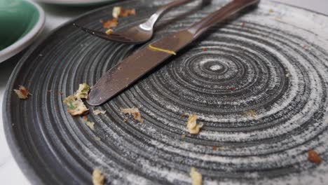 a dirty plate with food scraps after a meal