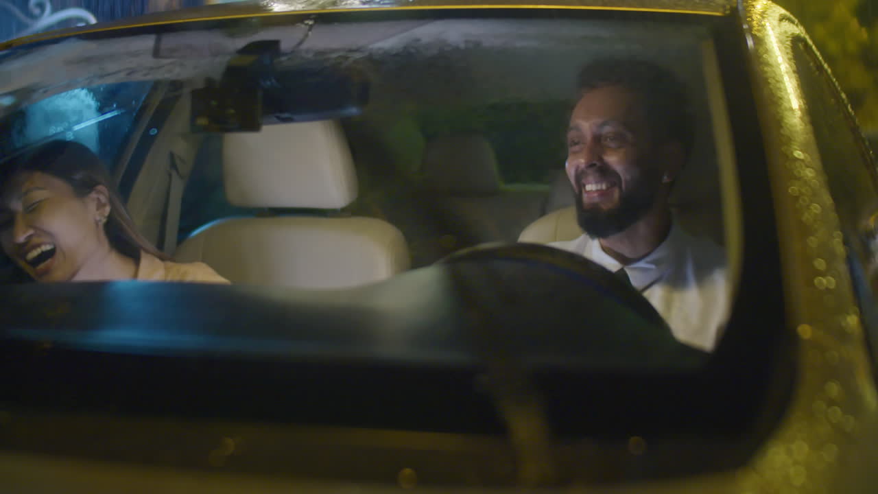 Coworkers Chatting in Car at Rainy Night