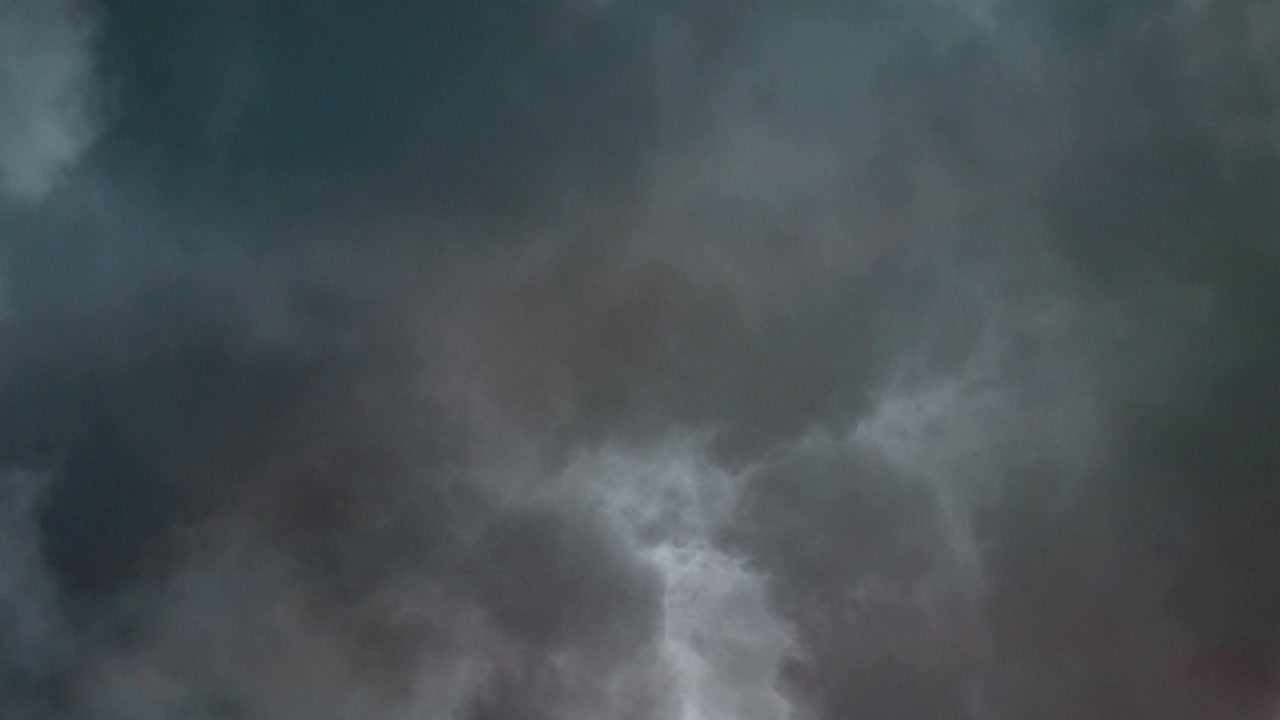 a thunderstorm with a thunderstorm striking the clouds moving forward