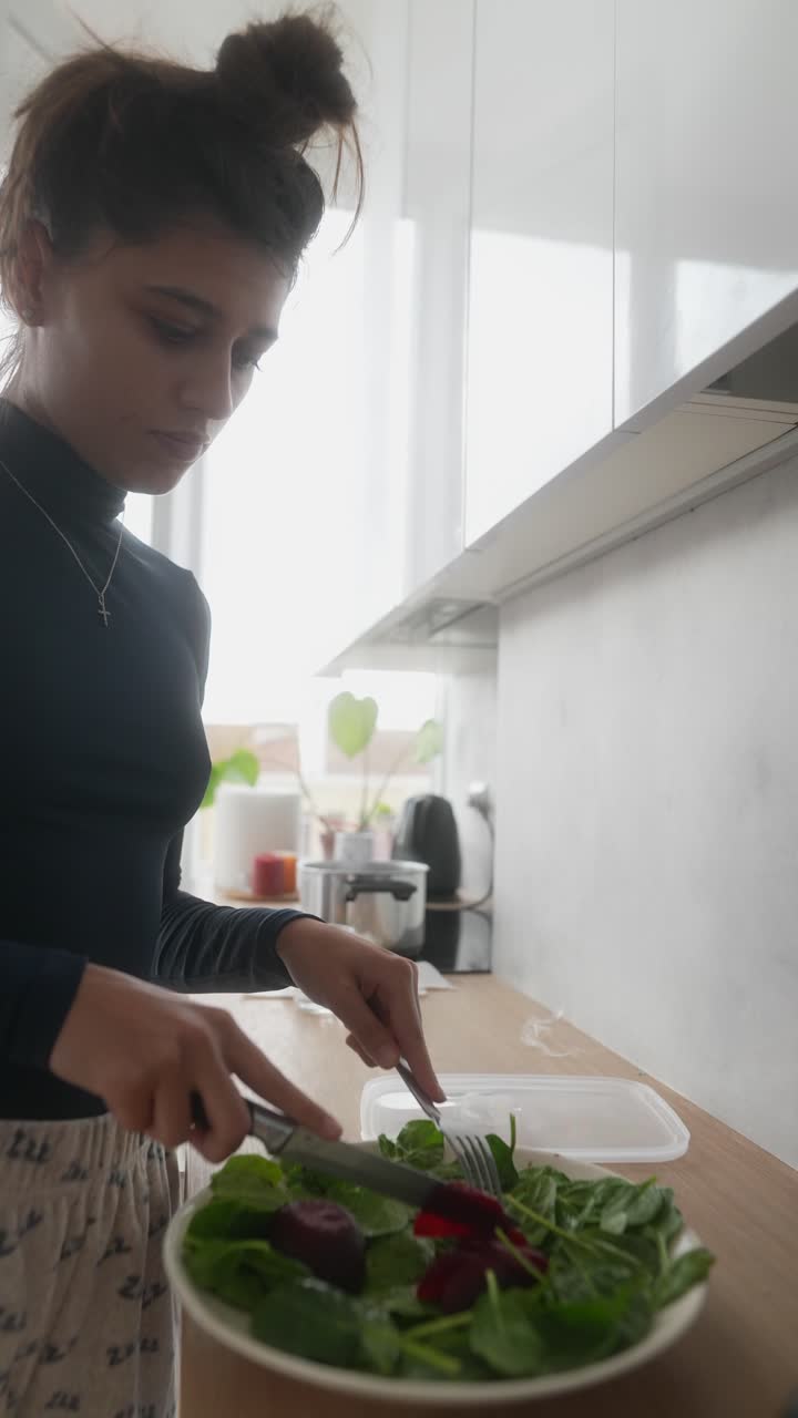 Woman Preparing a Beet and Spinach Salad in the Kitchen