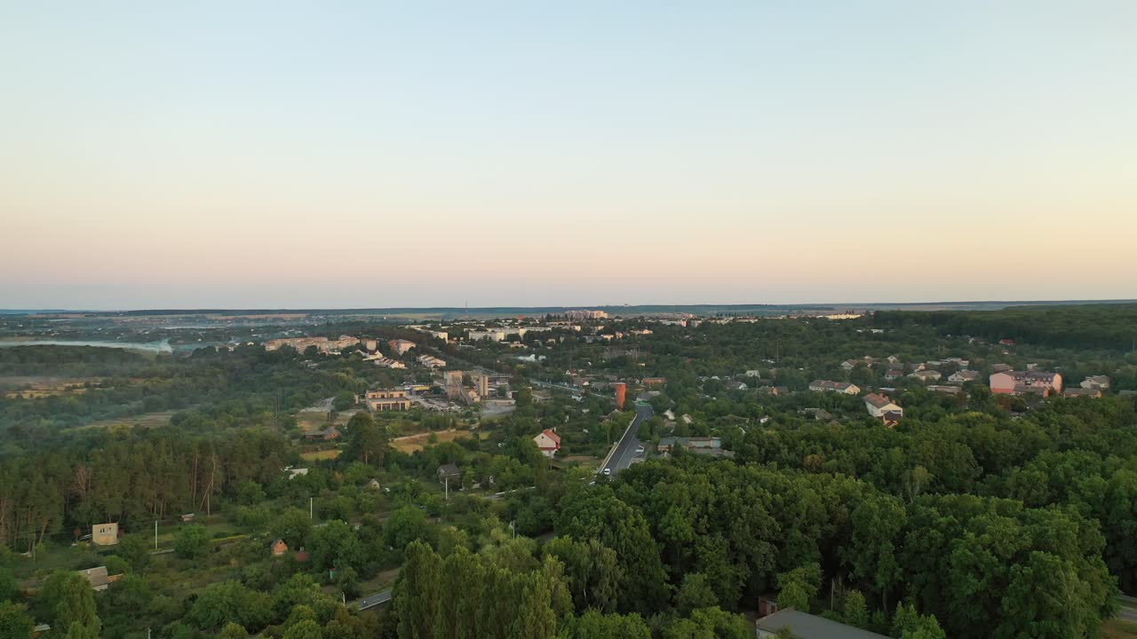 Aerial footage of small town in summertime. Beautiful landscape of small town or village with houses and green trees. Aerial view.