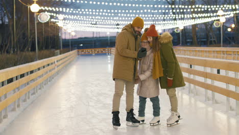 family ice skating selfie at night