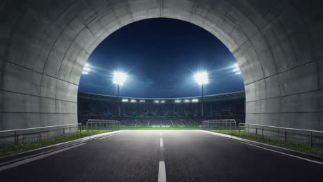 view from a tunnel leading into a lit sports stadium at night