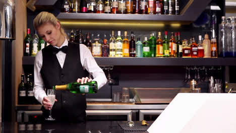 attractive blonde pouring champagne at the bar