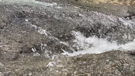closeup of the clean gurgling of the river on the rocks