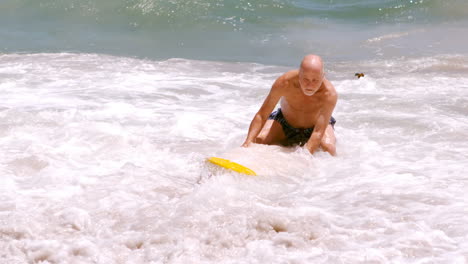 a mature man is trying his surfboard