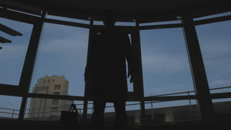 person at window in urban setting