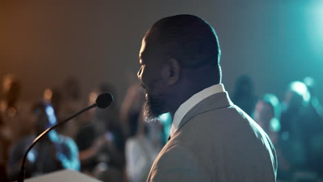 man giving a speech at a conference