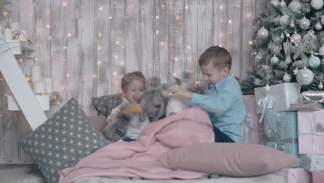 junior schoolboy and toddler girl play happily in bedroom