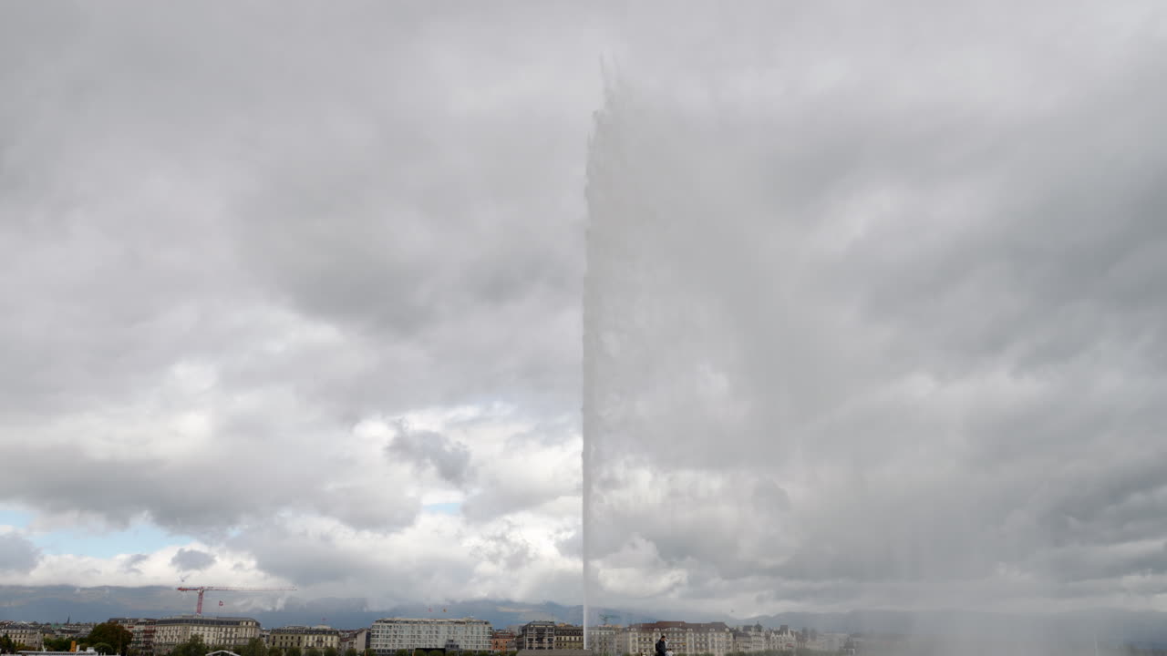 Jet d'Eau in Geneva Famous Water Fountain on the Lake on a Cloudy Day STATIC