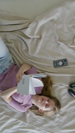 woman reading a book in bed