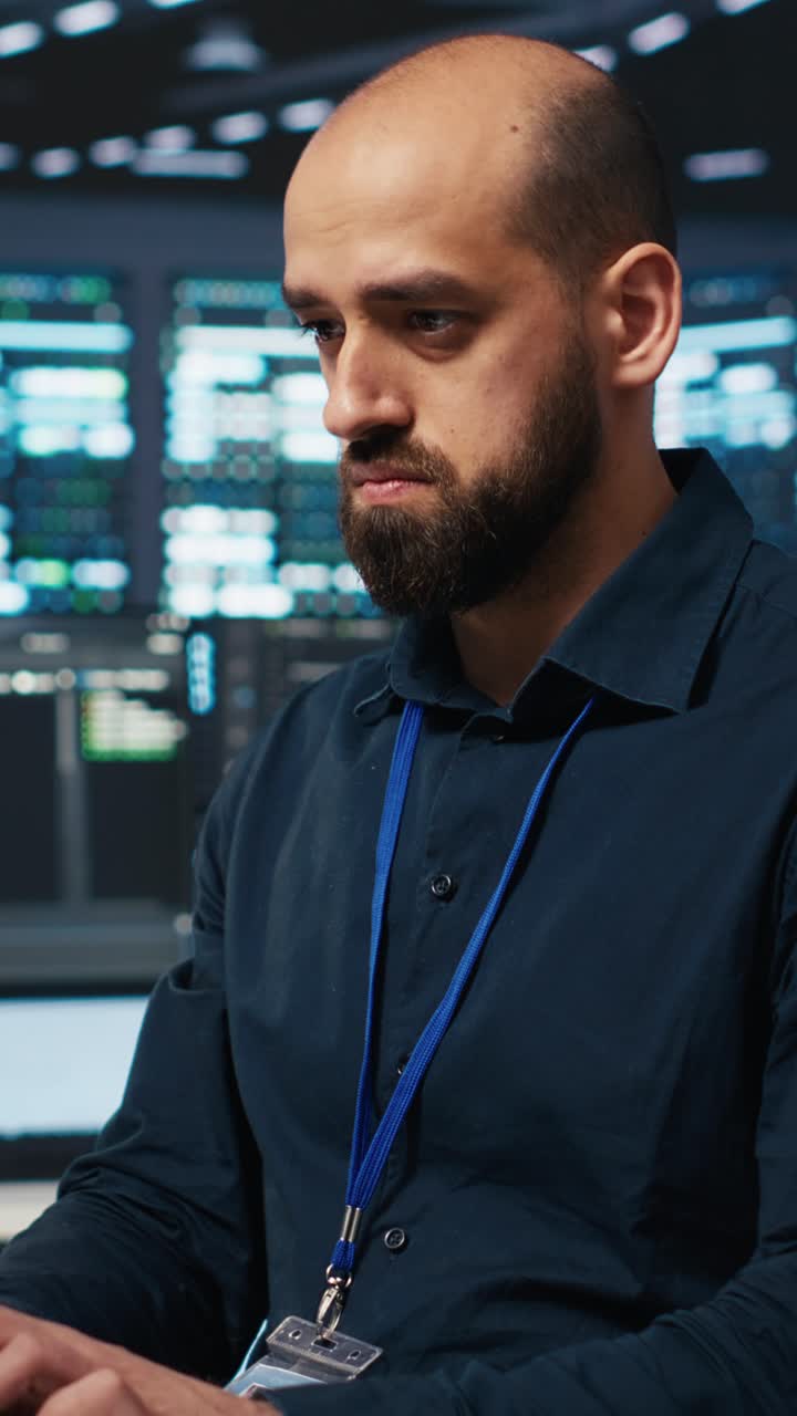 Focused Programmer Typing on Keyboard in a Data Center