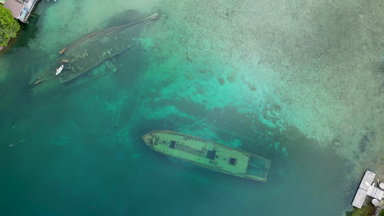 Aerial View of Two Sunken Shipwrecks in a Crystal Clear Lake