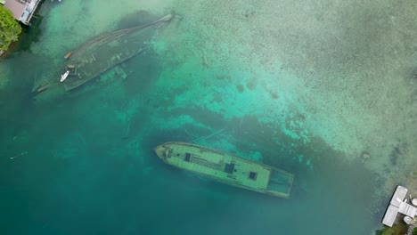aerial view of two sunken shipwrecks in a crystal clear lake