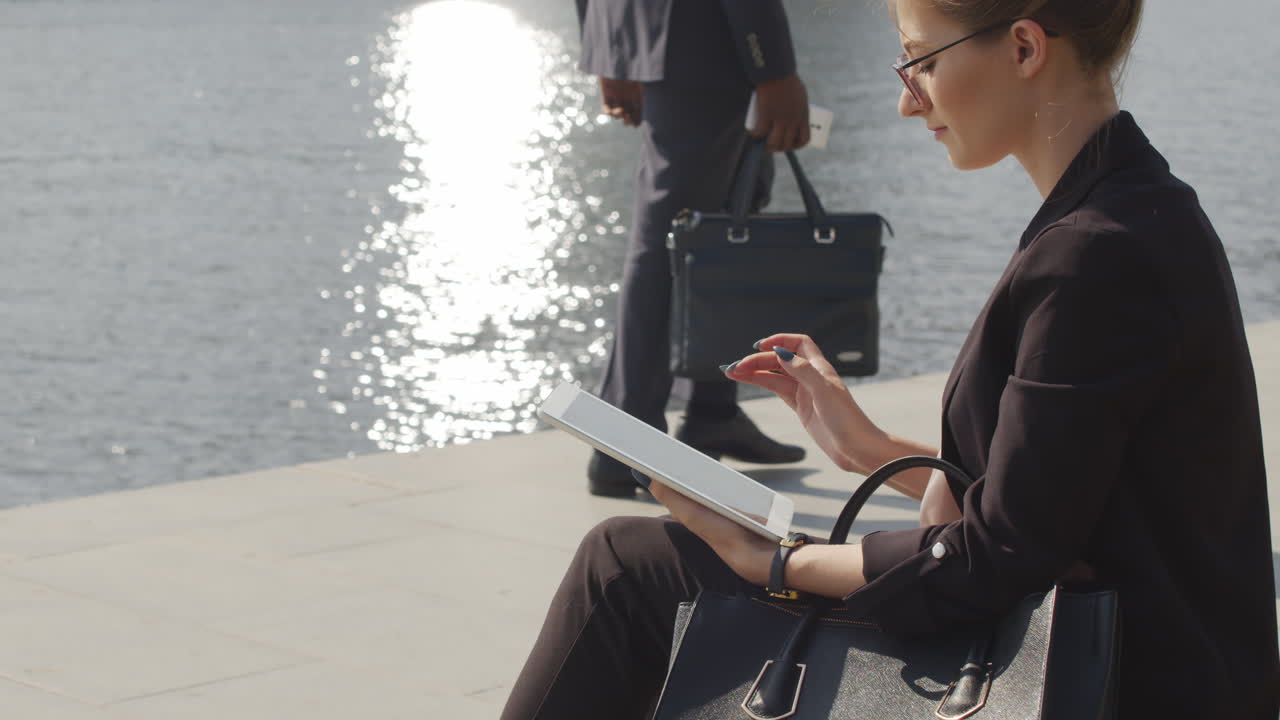 Business Woman Working On Tablet By River