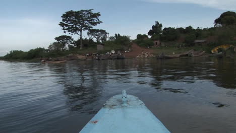 pov of a fishing boat's departure from the shore of lake victoria in uganda