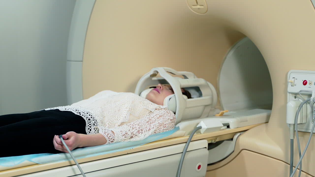 Female patient in MRI device. Modern medical equipment in hospital. Woman doing tomography in a magnetic resonance image machine.