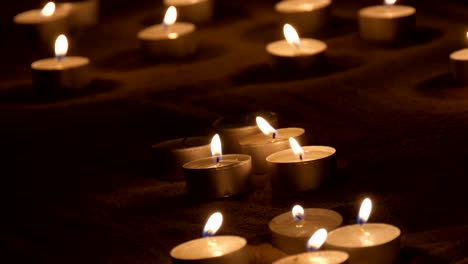 candles burning in the sand