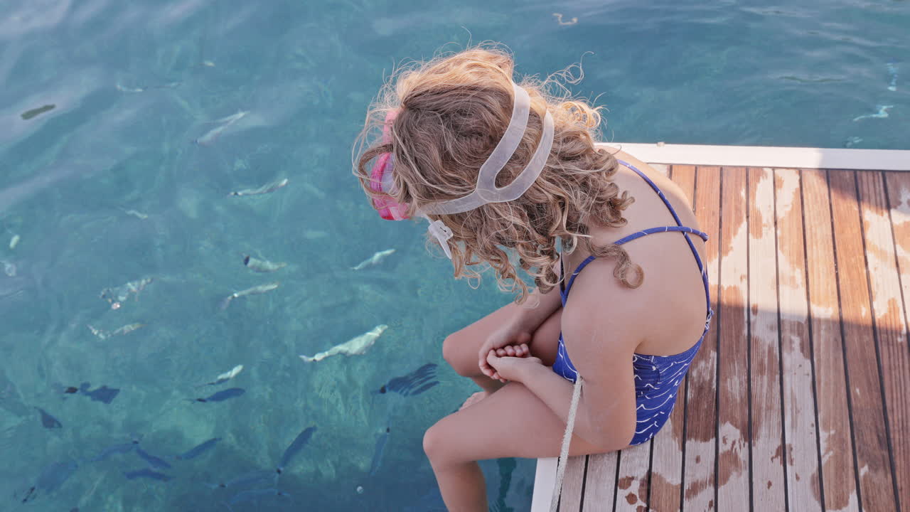 small girl on the swim deck of a yacht in greece
