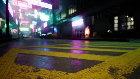 vibrant urban street with neon lights reflected in wet pavement at night