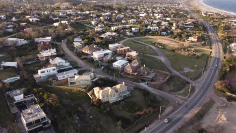 aerial flyover luxury villas in hill with ocean view in punta del este,uruguay