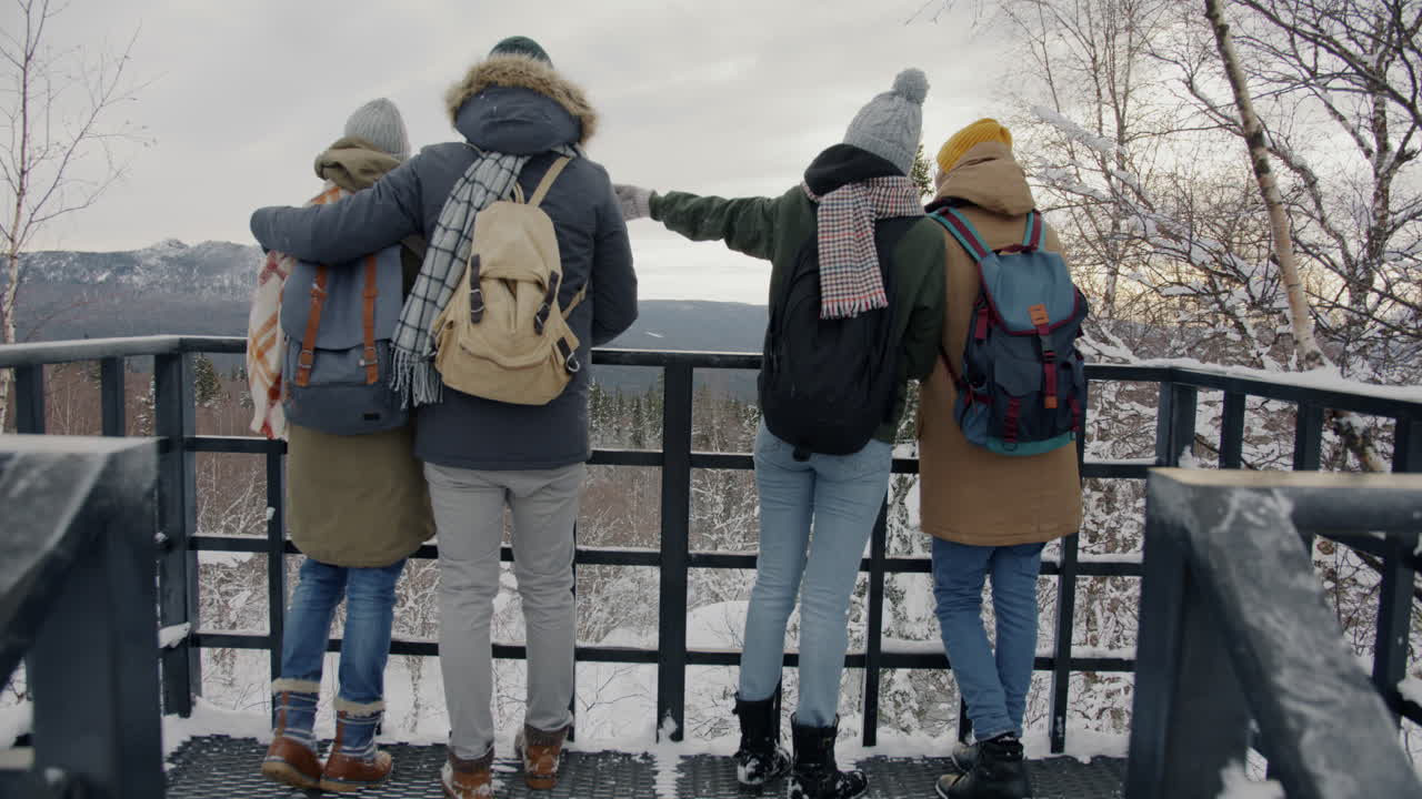 Friends enjoying the winter view from an observation deck