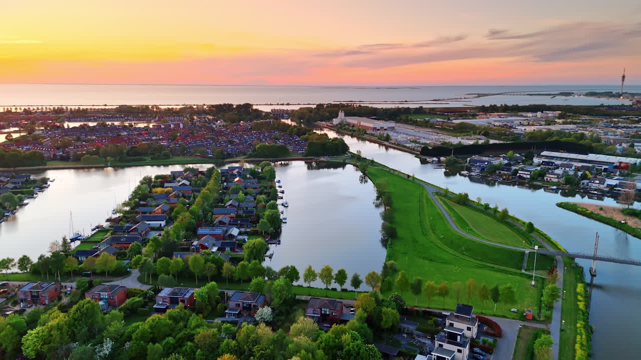 Beautiful Dutch sunset views. Vibrant sunset casts colorful hues over the serene Dutch landscape filled with green trees and calm waters