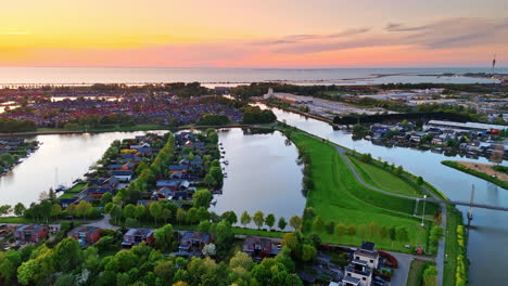 beautiful dutch sunset views. vibrant sunset casts colorful hues over the serene dutch landscape filled with green trees and calm waters