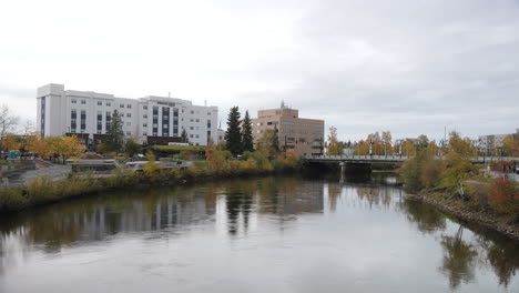 wide angle view of the downtown skyline of fairbanks, alaska during autumn, bridge over the chena river