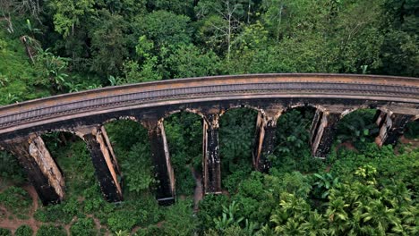 stunning aerial drone footage of the famous nine arches bridge in ella, sri lanka.