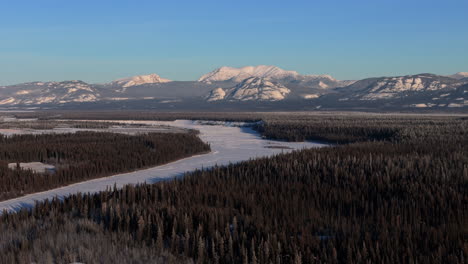 frozen yukon river during winter in canada - aerial shot