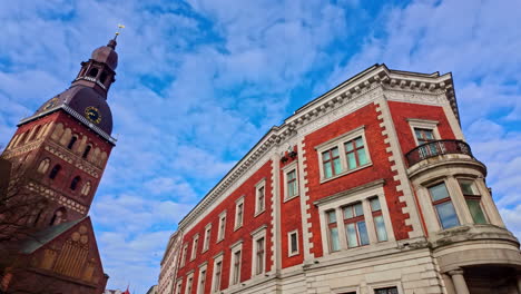 historic architecture and a church tower against a vibrant blue sky in an old european city