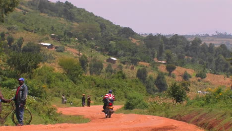 A-person-on-a-motorbike-pulls-to-the-side-of-a-rural-road