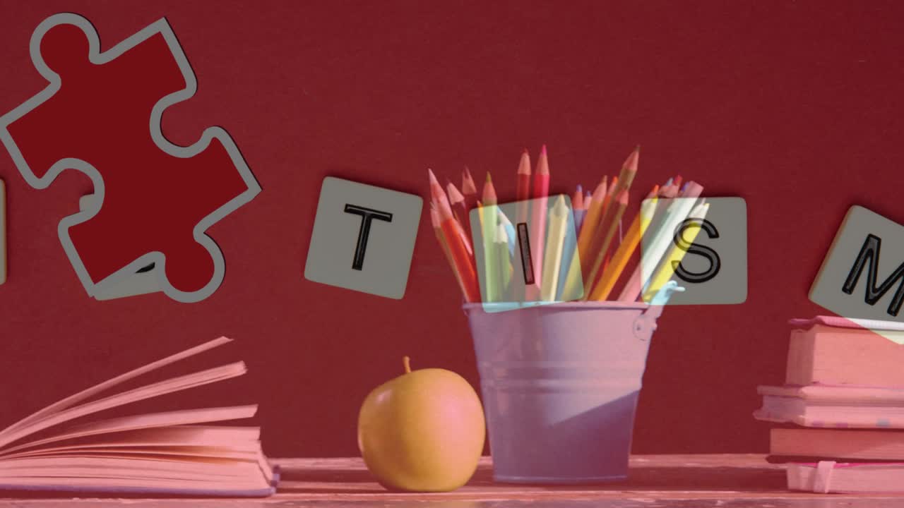 Animation of puzzles falling over autism text and colour pencils