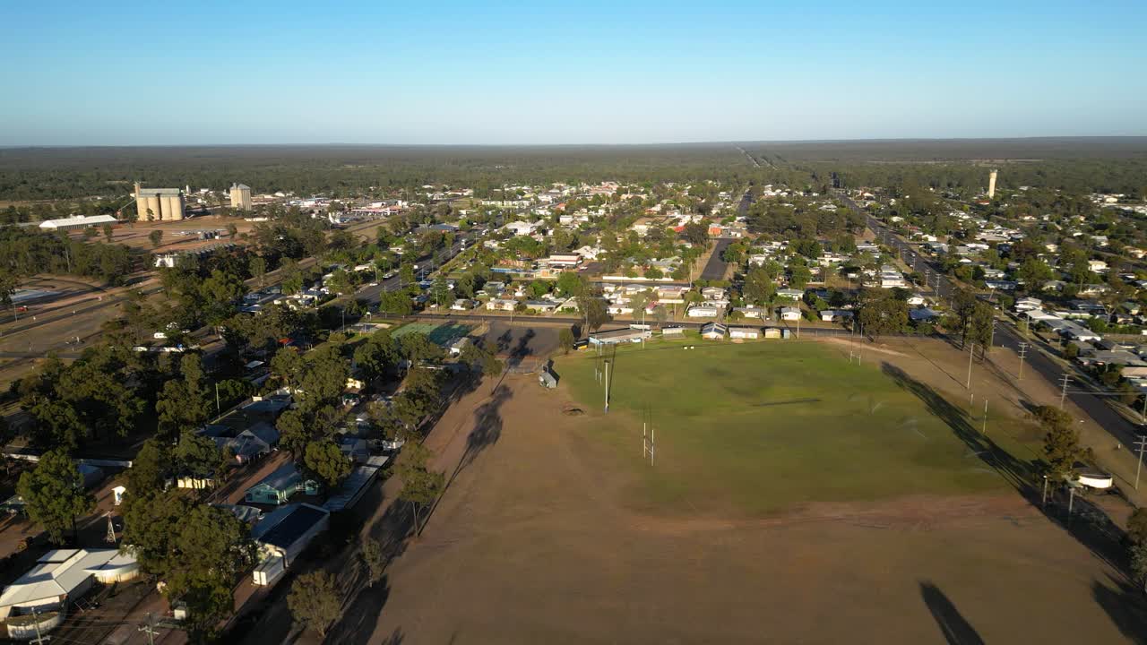 Approaching aerial views over residential housing and sporting fields in the small town of Miles Queensland.