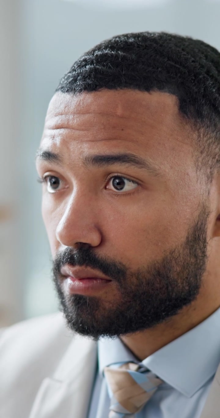 Focused Businessman Looking Down and Thinking in Office