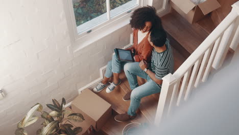 Tablet,-home-stairs-and-couple-above-with-moving