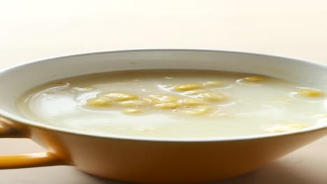 creamy corn soup in a yellow mug