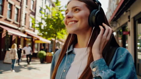 woman enjoying music on city street