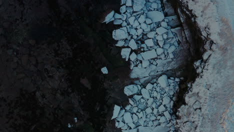 Top-down-bird's-eye-view-of-snow-covered-rocky-slabs-of-Ireland-wild-atlantic-way