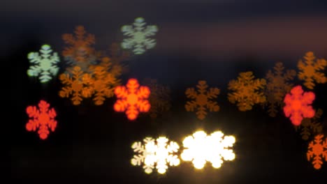 Beautiful-snowflake-shaped-bokeh-from-moving-car-and-traffic-lights-at-the-evening,-Christmas,-winter-or-holiday-background-concept,-copyspace