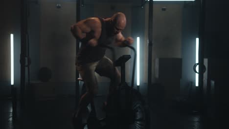man working out on an air bike in a gym