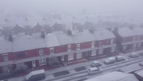 Snowy-frozen-UK-neighbourhood-homes-during-cost-of-living-energy-crisis-aerial-view