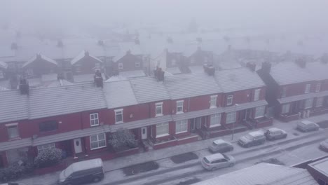 snowy frozen uk neighbourhood homes during cost of living energy crisis aerial view