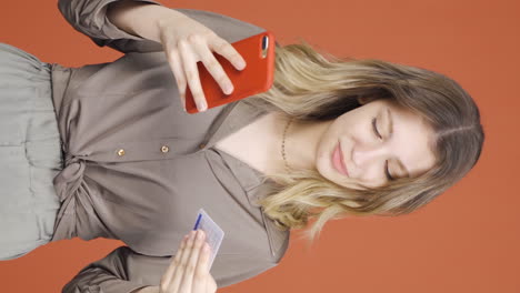 vertical video of young woman shopping with credit card.