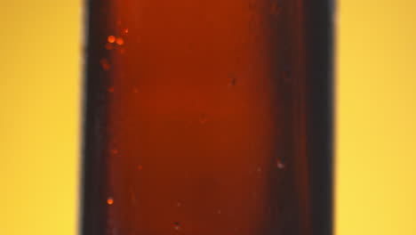 Pull-Focus-Shot-Of-Condensation-Droplets-Running-Down-Side-Of-Bottle-Of-Cold-Beer-Or-Soft-Drink-With-Copy-Space