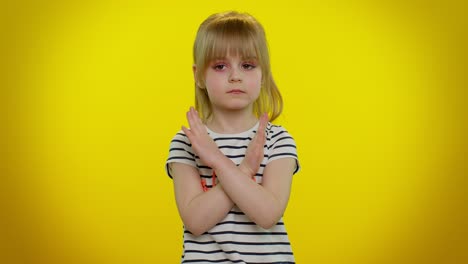 Little-child-kid-girl-say-no-hold-palm-folded-crossed-hands-in-stop-gesture,-warning-of-finish