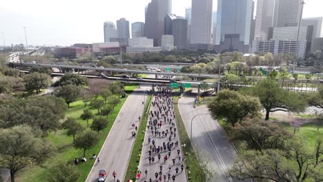 Top-down-Aerial-of-people-competing-in-city-marathon-on-the-main-road