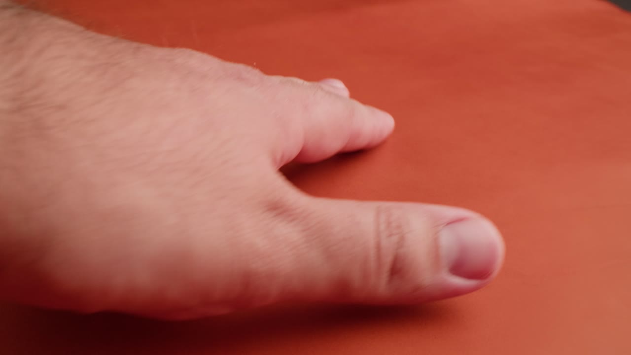 Hand on orange surface