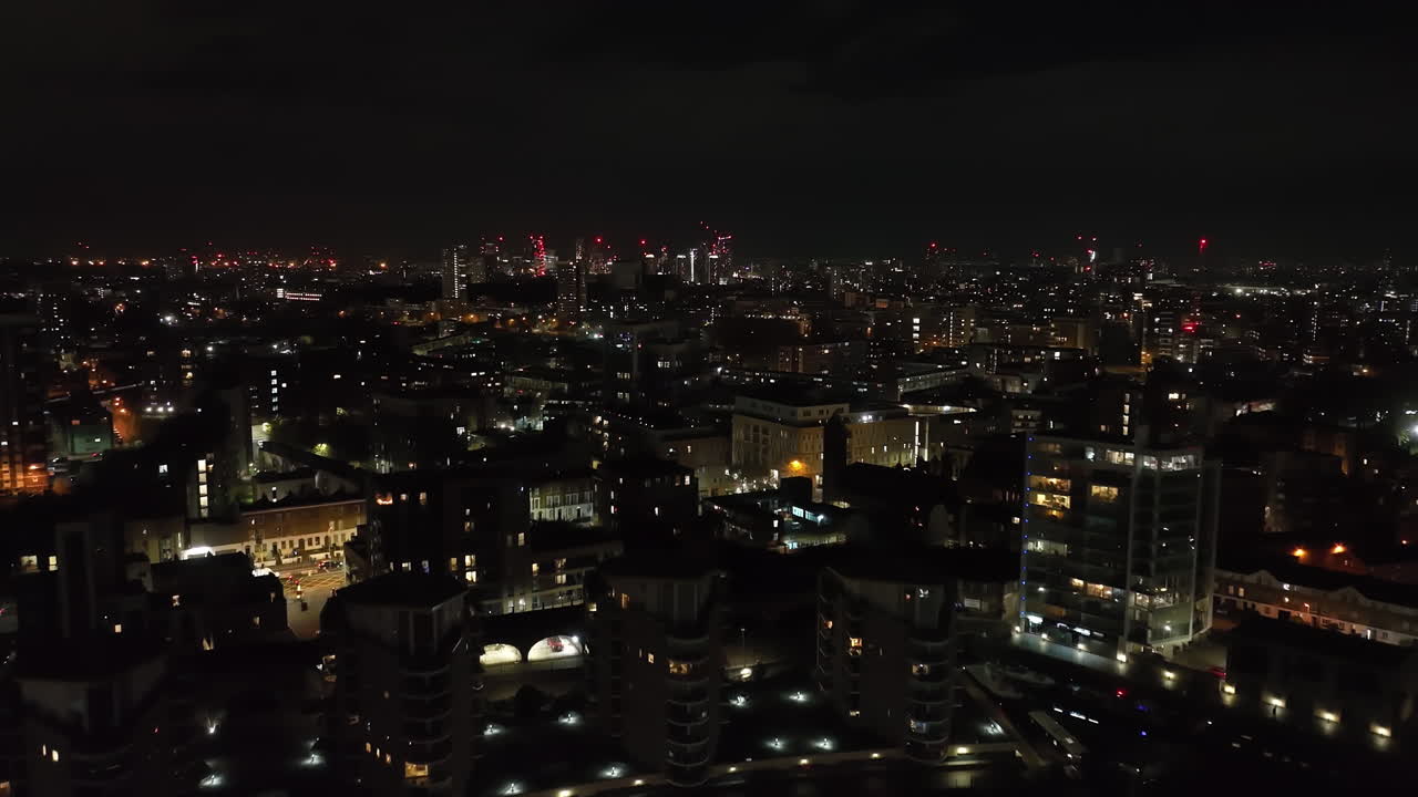 Aerial view rising over the cityscape of Limehouse, night in London, England